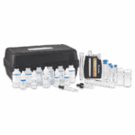 A Laundry Testing Outfit - Model LDR - 3095-02 water testing kit with labeled bottles, a black carrying case, test tubes, droppers, a color comparator, and clear sample vials arranged on a white surface.