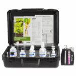 A black plastic carrying case opens to reveal the Hydroponics 4-Way Test Kit - 3561-01, complete with reagent bottles, test tubes, droppers, a color comparison chart, instruction sheets, and images of plants on the included papers.