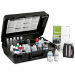 A black plastic Aquaponics Kit - 3637 case containing various bottles, test tubes, and chemical solutions for water testing, with a color comparison chart and an instruction manual labeled Aquaponics beside the kit.