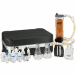 The AT Visual Water Quality Sales Demo Kit - 4-3003-01 features bottles of chemical reagents, two flasks, a cylindrical filter, a black carrying case, a test tube stand, and a color comparison chart arranged on a white surface.