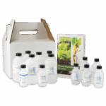 Un conjunto de botellas de plástico con etiquetas científicas está colocado junto a un folleto titulado Estudios de Nutrición Vegetal - 5940. Detrás de los objetos se coloca una funda blanca de cartón con asa para el portador.