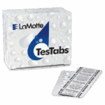 A box labeled LaMotte TesTabs with a blue water droplet design sits next to a blister pack containing round tablets for pH (Phenol Red) testing. The blister pack displays the TesTabs branding and tablet information.