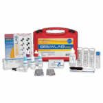 A red BrewLab® Basic - 7189-02 kit with vials, droppers, bottles, test tubes, a brush, instruction booklet, and color charts arranged neatly in front of the case for water testing.
