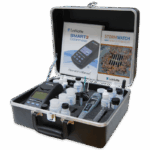 A black carrying case contains scientific instruments, including a colorimeter, test tubes, reagents, droppers, and manuals labeled SMART3 Colorimeter and StormWatch MS4 Water Screening Kit - 7449.